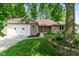 Beautiful brick home featuring a manicured lawn, mature trees, and an attached two-car garage at 180 Hollowview Dr, Noblesville, IN 46060