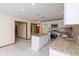 Well-lit kitchen with island, stainless appliances, and tiled backsplash at 180 Hollowview Dr, Noblesville, IN 46060