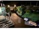 Backyard at night with steps, a walkway, landscaping, and benches under lamplight at 1810 S Raceway Rd, Indianapolis, IN 46231