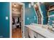 Bathroom vanity with marble countertop, vanity mirror, and walk-in closet in the background at 1810 S Raceway Rd, Indianapolis, IN 46231