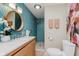 Stylish bathroom with a modern wood vanity, round mirror, walk-in shower, and eye-catching geometric tile at 1810 S Raceway Rd, Indianapolis, IN 46231