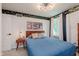 Charming bedroom features unique space-themed wallpaper, a blue quilted bedspread, and a mid-century modern ceiling light at 1810 S Raceway Rd, Indianapolis, IN 46231
