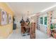 Bright dining room with a rustic wood table, modern lighting, and colorful curtains, perfect for Gathering gatherings at 1810 S Raceway Rd, Indianapolis, IN 46231