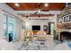 Inviting living room boasts a stone fireplace, wood ceiling, and modern decor for cozy, stylish living at 1810 S Raceway Rd, Indianapolis, IN 46231