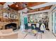 Cozy living room with a stone fireplace, built-in shelves, and comfortable seating, perfect for relaxing and entertaining at 1810 S Raceway Rd, Indianapolis, IN 46231