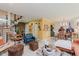 Eclectic living room with unique seating, modern decor, and an open concept layout to the dining area at 1810 S Raceway Rd, Indianapolis, IN 46231