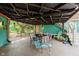 Covered patio area providing a great place for outdoor entertaining, complete with a dining table and chairs at 1810 S Raceway Rd, Indianapolis, IN 46231