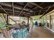 Covered patio is ready for entertaining with stylish outdoor seating and a unique corrugated metal awning at 1810 S Raceway Rd, Indianapolis, IN 46231