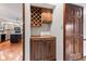 Wet bar area adjacent to the kitchen featuring wooden cabinets at 1826 Spruce Dr, Carmel, IN 46033