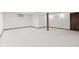 A finished basement featuring neutral carpet and a decorative beam at 1826 Spruce Dr, Carmel, IN 46033