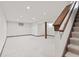 Spacious basement features neutral carpet, stairs, and a support beam at 1826 Spruce Dr, Carmel, IN 46033