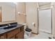 Bathroom featuring granite counters, wood cabinets, toilet, and glass door shower stall at 1826 Spruce Dr, Carmel, IN 46033