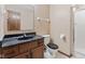 Bathroom showcasing granite counters, wood cabinets, toilet, and glass door shower stall at 1826 Spruce Dr, Carmel, IN 46033