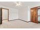 Bedroom with wood trim, plush carpet, and closet at 1826 Spruce Dr, Carmel, IN 46033