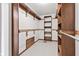 Walk-in closet with neutral carpet, white walls, wooden shelves and hanging racks at 1826 Spruce Dr, Carmel, IN 46033