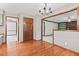 Dining room with hardwood floors and chandelier provides access to other rooms in the home at 1826 Spruce Dr, Carmel, IN 46033