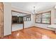 Bright dining area features hardwood floors, a chandelier, and a pass-through to the living room with fireplace at 1826 Spruce Dr, Carmel, IN 46033