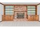Close-up of living room fireplace with brick surround and custom wood shelves at 1826 Spruce Dr, Carmel, IN 46033
