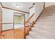 Spacious foyer with hardwood floors, a staircase with carpet, and views into other rooms at 1826 Spruce Dr, Carmel, IN 46033