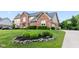 Beautifully landscaped front yard of a brick home with a well-maintained lawn at 1826 Spruce Dr, Carmel, IN 46033