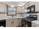 This kitchen showcases granite countertops, tiled backsplash, modern appliances, and ample natural light at 1826 Spruce Dr, Carmel, IN 46033