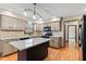 Updated kitchen featuring granite countertops, stylish cabinets, and modern lighting fixtures at 1826 Spruce Dr, Carmel, IN 46033