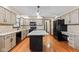 Spacious kitchen featuring an island, granite counters, updated cabinets, and stainless steel appliances at 1826 Spruce Dr, Carmel, IN 46033