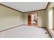Bright living room with neutral carpet, large windows, and classic trim details at 1826 Spruce Dr, Carmel, IN 46033