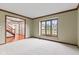 Bright living room with large window, soft carpet, and wood trim at 1826 Spruce Dr, Carmel, IN 46033