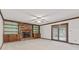 Living room features a brick fireplace, built-in shelves, and sliding glass doors at 1826 Spruce Dr, Carmel, IN 46033