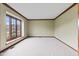 Bright living room with neutral carpet, large windows, and classic trim details at 1826 Spruce Dr, Carmel, IN 46033