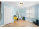 Bright bedroom with light blue walls, hardwood floors, and a minimalist design at 188 Maple Ln, Franklin, IN 46131