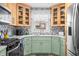 Kitchen features stainless appliances, tile backsplash, stylish lighting and light green cabinets at 188 Maple Ln, Franklin, IN 46131