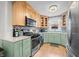 Kitchen featuring modern stainless steel appliances and light green and light wood cabinets at 188 Maple Ln, Franklin, IN 46131