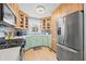 Well-lit kitchen boasts stainless appliances, tile backsplash, and light green and natural wood cabinets at 188 Maple Ln, Franklin, IN 46131