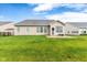 An exterior shot of the backyard with patio and well-maintained lawn, perfect for outdoor activities and gatherings at 18991 Round Lake Rd, Noblesville, IN 46060