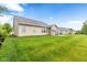 Spacious backyard with a well-manicured lawn extending from the house, offering a great outdoor space at 18991 Round Lake Rd, Noblesville, IN 46060