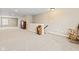 Basement with neutral walls and carpet features a staircase and natural wood shelving at 18991 Round Lake Rd, Noblesville, IN 46060