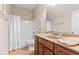 Well-lit bathroom with a wooden vanity and a shower/tub combination at 18991 Round Lake Rd, Noblesville, IN 46060