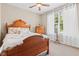 Comfortable bedroom with wooden furniture and a window with white curtains provides ample natural light at 18991 Round Lake Rd, Noblesville, IN 46060