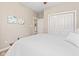 Bright bedroom with a white bed, white closet doors and walls, and neutral carpet at 18991 Round Lake Rd, Noblesville, IN 46060