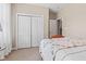 Bedroom with neutral walls and carpet features a white closet and white door at 18991 Round Lake Rd, Noblesville, IN 46060