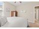 Neutral bedroom features a bed with white quilted bedding, a wooden dresser, and soft, neutral walls at 18991 Round Lake Rd, Noblesville, IN 46060