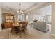 Open-concept dining room with neutral carpet and classic chandelier lighting at 18991 Round Lake Rd, Noblesville, IN 46060