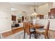 Dining room showcases an open floor plan with a view into the living room with fireplace and built-in bookcases at 18991 Round Lake Rd, Noblesville, IN 46060