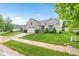 Attractive brick home featuring a manicured lawn, mature landscaping, and an attached two-car garage at 18991 Round Lake Rd, Noblesville, IN 46060