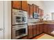 This modern kitchen boasts stainless-steel oven and microwave plus beautiful wooden cabinets at 18991 Round Lake Rd, Noblesville, IN 46060