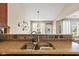 Kitchen sink area with granite countertops that opens to dining room at 18991 Round Lake Rd, Noblesville, IN 46060