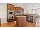 Kitchen with stainless appliances, granite counters, center island and wooden cabinets offers plenty of room at 18991 Round Lake Rd, Noblesville, IN 46060