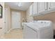 Laundry room with white washer and dryer, cabinets, and tiled floors at 18991 Round Lake Rd, Noblesville, IN 46060
